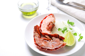 Delicious boiled lobster served on white table, closeup