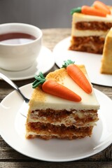 Delicious homemade carrot cake served on wooden table, closeup