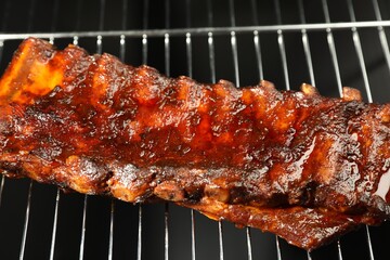 Delicious roasted pork ribs on grill, closeup