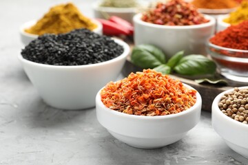 Different aromatic spices on grey table, closeup