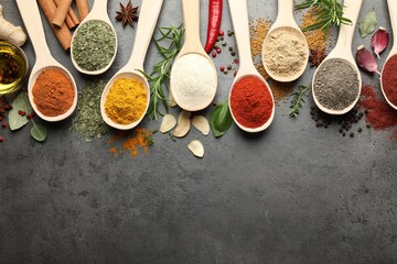Many different spices in spoons on grey table, flat lay. Space for text