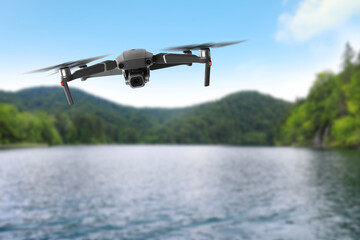 Drone with camera flying over bay. Unmanned aerial vehicle for surveillance