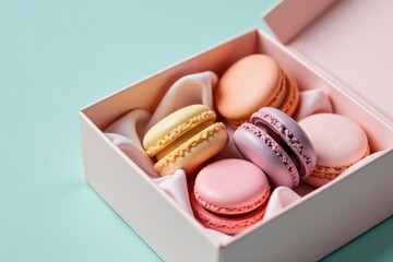 Fototapeta premium Pastel-colored macarons in a delicate pink gift box, nestled on a soft silk lining, creating a delightful and elegant presentation