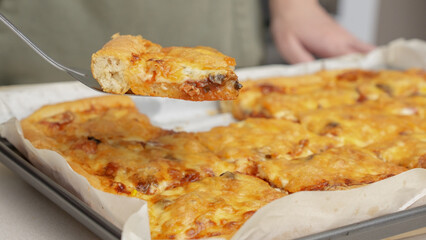 Homemade square pizza with cheese and sausage topping served on wooden table Square pizza, full cheese spread organic pizza healthy pizza