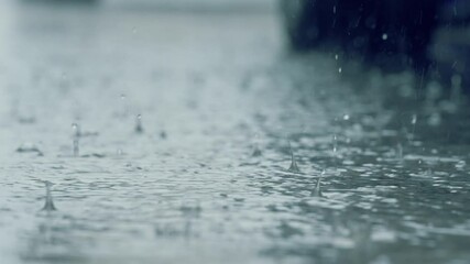 A car stopping through heavy rain on a wet road, captured in moody weather conditions. Concept of travel, solitude, rainy season, and atmospheric urban scenes - Powered by Adobe