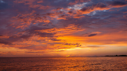 Fototapeta premium Dramatic Sunset Over the Sea with Colorful Clouds