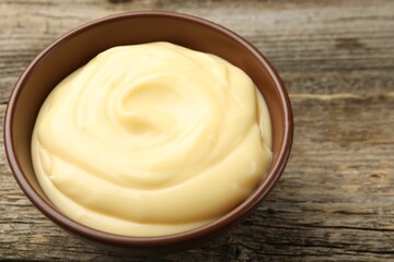 Tasty vanilla pudding on wooden table, closeup