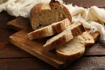 Pieces of fresh bread on wooden table, closeup