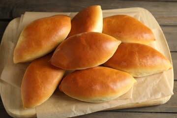 Tasty baked patties on wooden table, above view