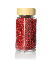 Red peppercorns in spice jar isolated on white