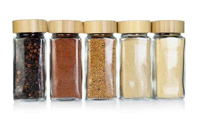 Many different aromatic spices in jars isolated on white
