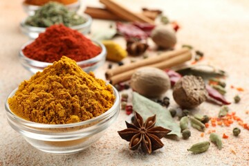 Different aromatic spices on color textured table, closeup