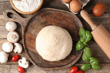 Making pizza. Different ingredients on wooden table, flat lay