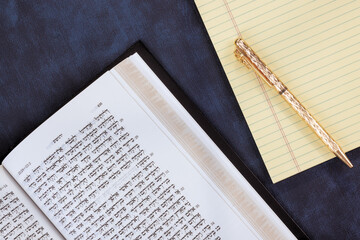 24 April 2025 Jerusalem Israel Ancient Hebrew Tanakh book lie open on table, with golden pen,...