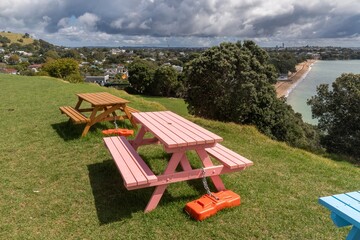 Picnic tables on a grassy hill on North Head overlooking Devonport, Auckland,, New ZealandThe...