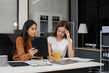 Businesswoman team working are under stress from financial data and report graph.