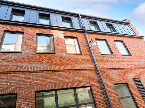 loft facade of an old industrial building after renovation against blue sky.
