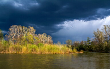 a large thundercloud over the Ural River during the spring flood