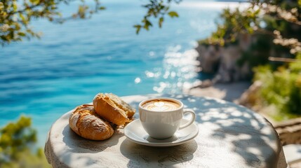 Cappuccino and bread rolls on a seaside table.