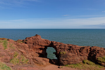 The Needle EÕe Sea Arch in Devonian Sandstone along the Arbroath Coastal walk, the remnant of a collapsed cave many years earlier.