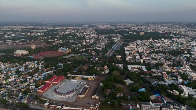 A mesmerizing aerial shot of Pondicherry's coastline, where the rising sun meets the calm waters and colorful colonial charm of the town.