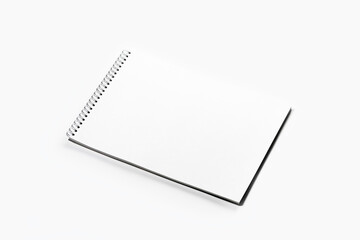 Open notebook with black spring on white background.