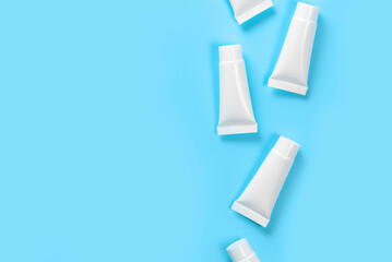 White closed tubes on the right side on blue background.