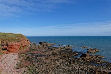 The Beach at Whiting Ness at the Arbroath Cliffs Coastal Walk with the weathered Rock strata...