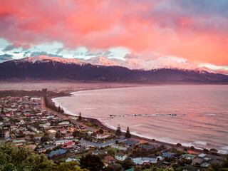 Kaikoura, New Zealand with a pink sky at sunrise.
