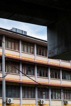 Old school building behind concrete structure