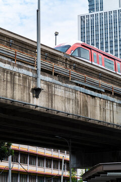 Electric urban transport monorail commuting through concrete cityscape