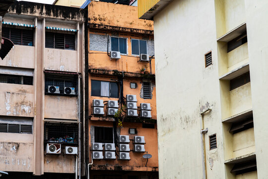 Crowded air conditioning units on old building in Kuala Lumpur, Malaysia