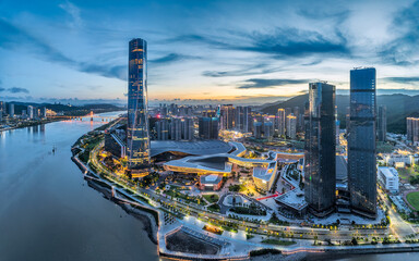 Panorama of the illuminated Zhuhai city skyline with modern architecture along the river at...