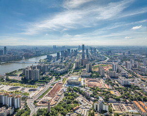 Obraz premium Aerial view of Guangzhou cityscape and the winding river under blue sky, China.