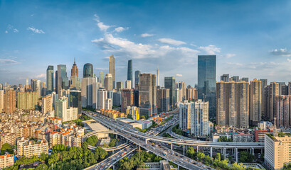 Obraz premium Modern cityscape skyline with complex highway interchange road traffic and tall buildings in Guangzhou, China.