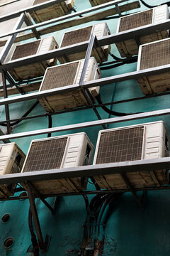 Industrial air conditioners stacked on urban facade Kuala Lumpur