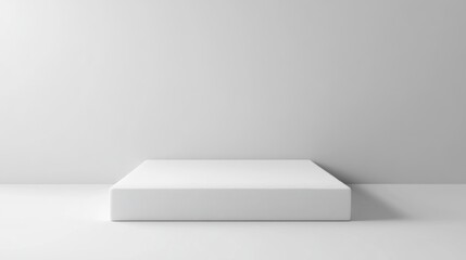 Blank white square platform against a plain wall