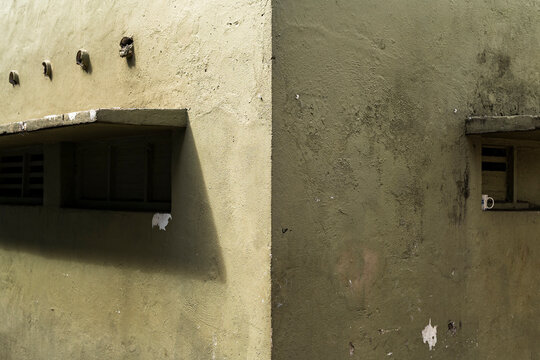 Minimalist architecture with green textured wall and shadows