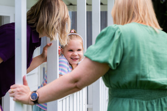 Speech therapist professional with girl interacting by cubby house talking and assessing child