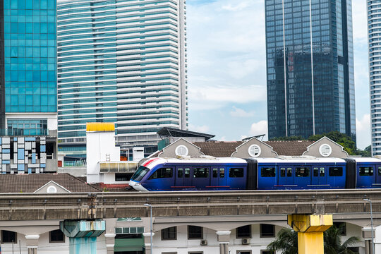 Electric monorail commuting above urban rooftops and modern skyscrapers