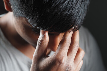 Fototapeta premium Young person showing deep contemplation or stress indoors