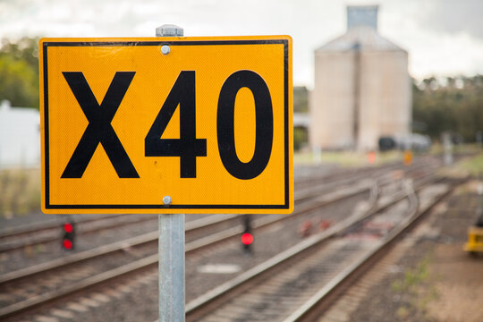 X40 sign beside train track near railway station