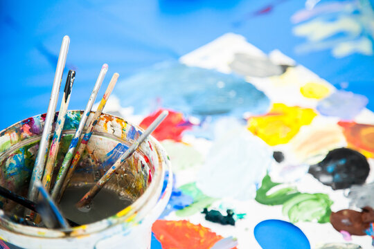 Coloured paint and painting brushes for children's art class