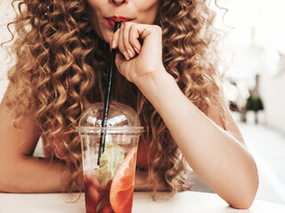Young beautiful smiling hipster woman with afro curls hairstyle. Woman in summer trendy clothes...