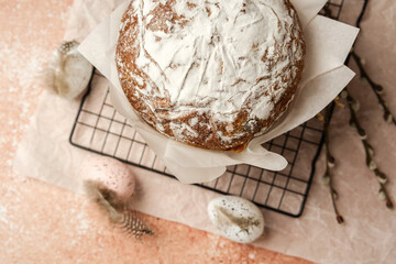 Traditional Easter cake with powdered sugar and speckled eggs on parchment paper. Festive food concept for spring holiday.