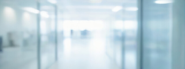 Blurred hallway interior with glass walls and doors light and airy atmosphere.
