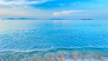 Blue sea waves gently rolling on the ocean surface under natural daylight.