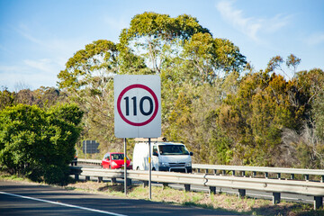 110 speed sign beside highway