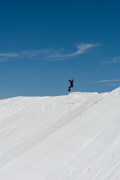 snowboarding practicing jumps in a terrain park