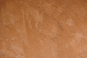 Rough orange cement plaster texture, close-up photo